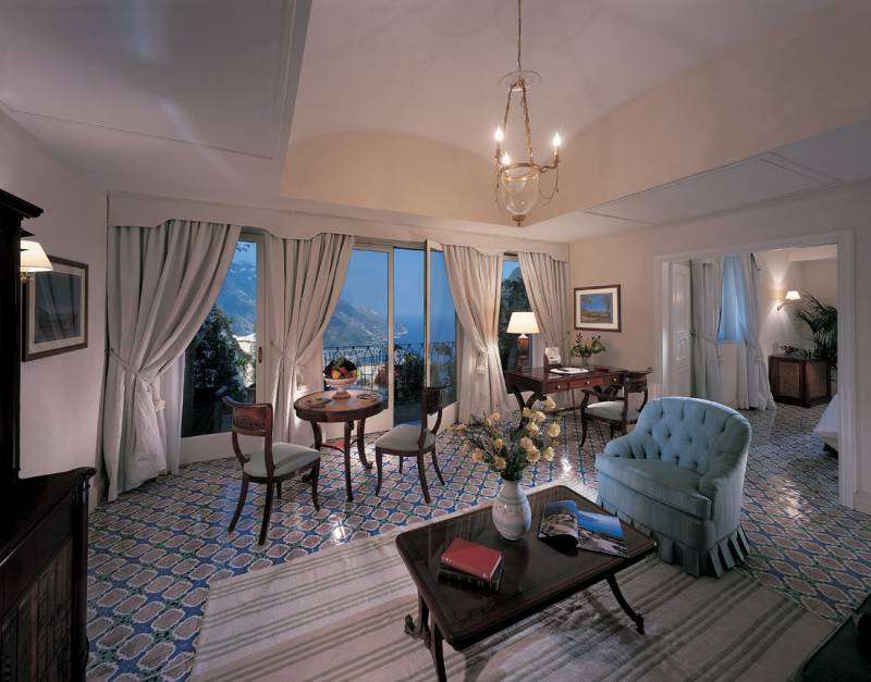 Living area of a Deluxe Suite, with private terrace and sea view
