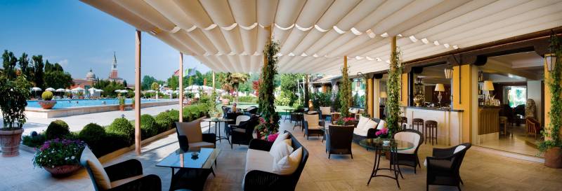 The outdoor lounge area of the Bar Gabbiano, overlooking the pool
