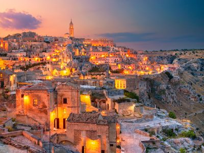 Cityscape aerial image of medieval city of Matera, Italy during beautiful sunset.